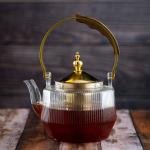 Luxury undulating glass teapot with gold accents and wooden handle
