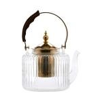 Clear glass teapot with a wood 