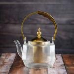 Luxury undulating glass teapot with gold accents and wooden handle