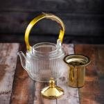 Luxury undulating glass teapot with gold accents and wooden handle