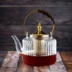 Luxury undulating glass teapot with gold accents and wooden handle