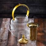 Luxury undulating glass teapot with gold accents and wooden handle